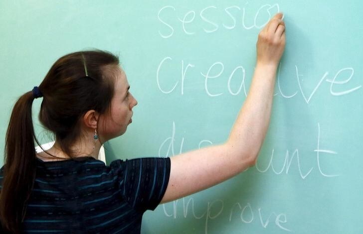 English teacher Laura Thomas, who is a British citizen, writes on a blackboard as she conducts a lesson in the town of Lesosibirsk, north of the Russian Siberian city of Krasnoyarsk, April 24, 2015. Thomas, 25, a graduate of the University of Cambridge, developed an interest in the Russian language and culture as a teenager, and left her native town of Congleton, Cheshire in Britain for Lesosibirsk seven months ago to educate Russian trainee teachers in the English language at a local educational institute, a branch of the Siberian Federal University. Thomas has since experienced her first severe Siberian winter and has already made new acquaintances among the local residents. She plans to live and work in the region for at least several years to come. REUTERS/Ilya Naymushin