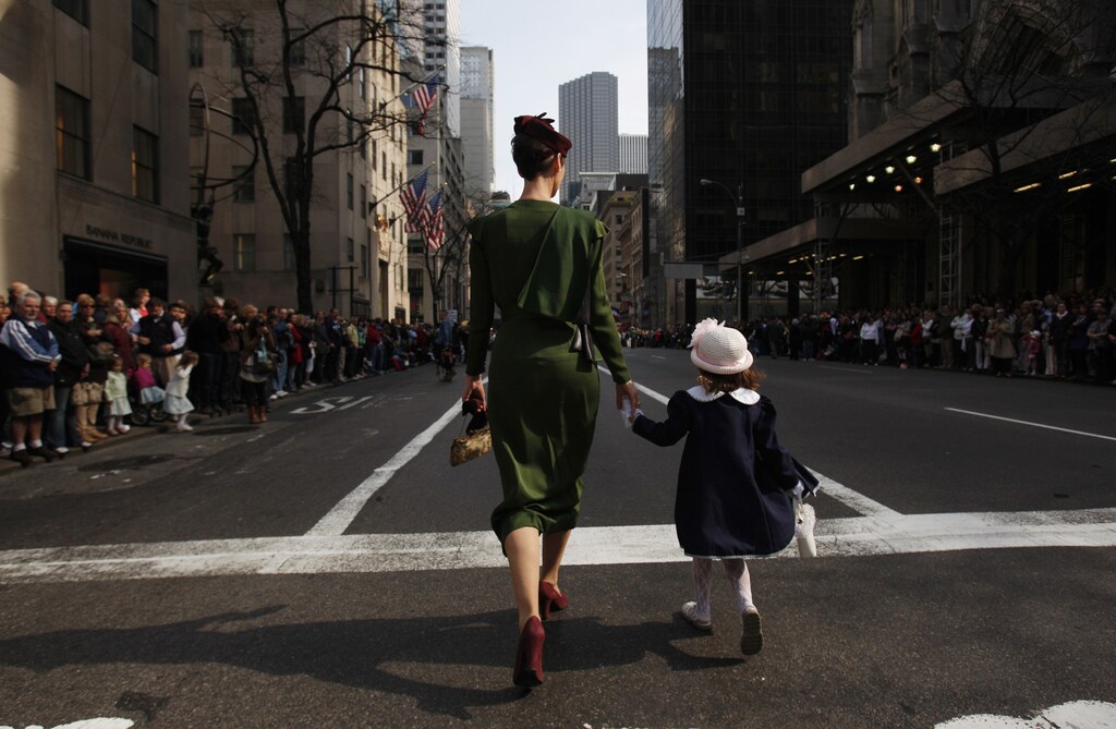 Joie Gregory and her daughter Catherine, 4, (R) walk down the street at the Easter Bonnet Parade in New York April 4, 2010.