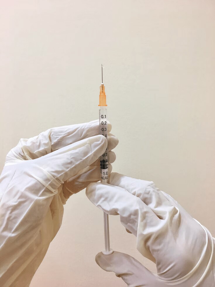 Person holding polio injection with white gloves