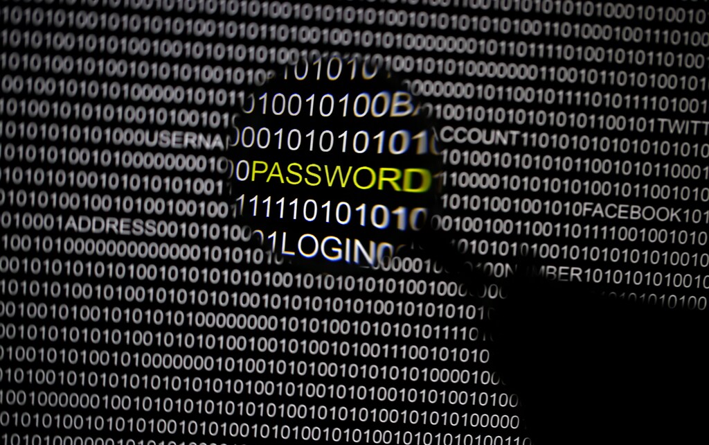 A magnifying glass is held in front of a computer screen in this picture illustration taken in Berlin May 21, 2013. The Financial Times' website and Twitter feeds were hacked May 17, 2013, renewing questions about whether the popular social media service has done enough to tighten security as cyber-attacks on the news media intensify. The attack is the latest in which hackers commandeered the Twitter account of a prominent news organization to push their agenda. Twitter's 200 million users worldwide send out more than 400 million tweets a day, making it a potent distributor of news. REUTERS/Pawel Kopczynski (GERMANY - Tags: CRIME LAW SCIENCE TECHNOLOGY) - BM2E95L11ML01