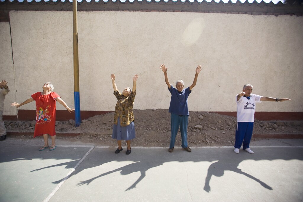 Elderly people exercise at a yard of the Canevaro old people's home in Lima March 24, 2010. REUTERS/Enrique Castro-Mendivil