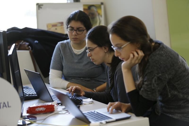 People work at Citi's tech hub in Tel Aviv, Israel December 14, 2015. For years, Israel tried to entice foreign banks to come and compete with domestic operators, with little success. Now foreigners are finally coming, but not to open up bank branches. It's Israel's skills in the flourishing space where technology and finance meet that is drawing them in. Picture taken December 14, 2015. REUTERS/Amir Cohen - GF10000266524