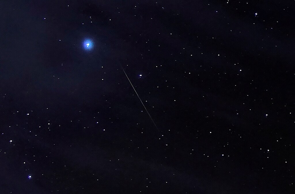 A meteor of the Orionid Meteor Shower, created by remnants of Halley's Comet which pass through the earth's atmosphere, streak through the night sky past Halley's Comet, above the San Rafael Swell outside Green River, Utah, U.S. October 23, 2019. REUTERS/George Frey - RC17B1D05AC0