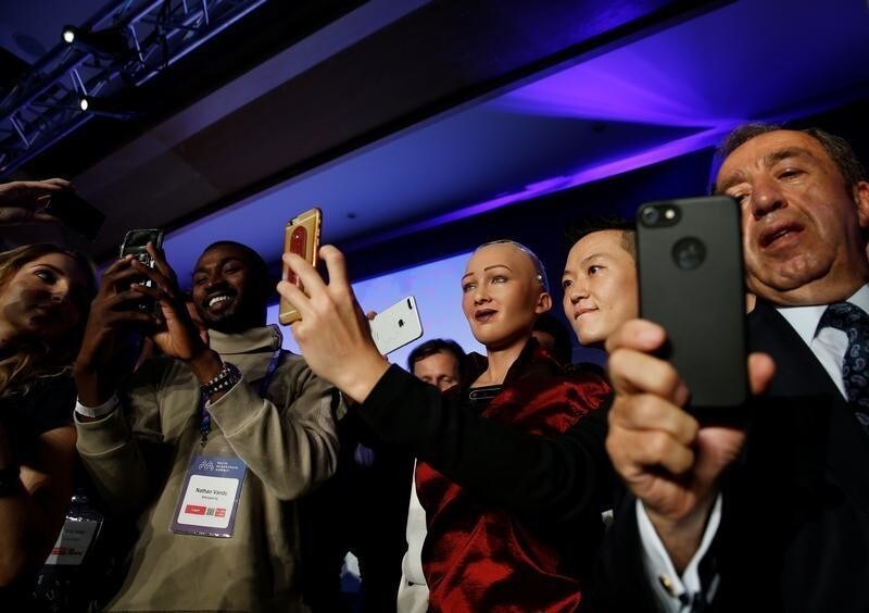 People take selfies with the humanoid robot Sophia, a creation of Hanson Robotics, at the Malta Blockchain Summit in St Julian's, Malta November 1, 2018. REUTERS/Darrin Zammit Lupi - RC15D5391AF0