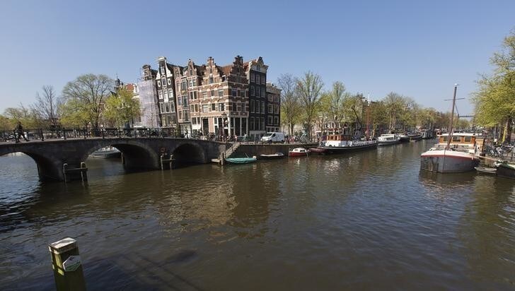 A view of one of the most photographed buildings at the intersection of Prinsengracht and Brouwersgracht canal in Amsterdam April 24, 2013. The Royal celebrations in the Netherlands this week put the country and the capital Amsterdam on front pages and television screens around the world with an orange splash. There's plenty to see and do in 48 hours in this compact city, where the world-famous Rijksmuseum only recently reopened after an extensive renovation. Picture taken April 24, 2013. To match story TRAVEL-AMSTERDAM/ REUTERS/Michael Kooren (NETHERLANDS - Tags: TRAVEL SOCIETY)