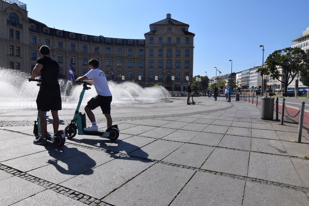 E-scooter users with scooters rented out from micromobility firm Tier in Munich, Germany, September 5, 2021. REUTERS/Nick Carey
