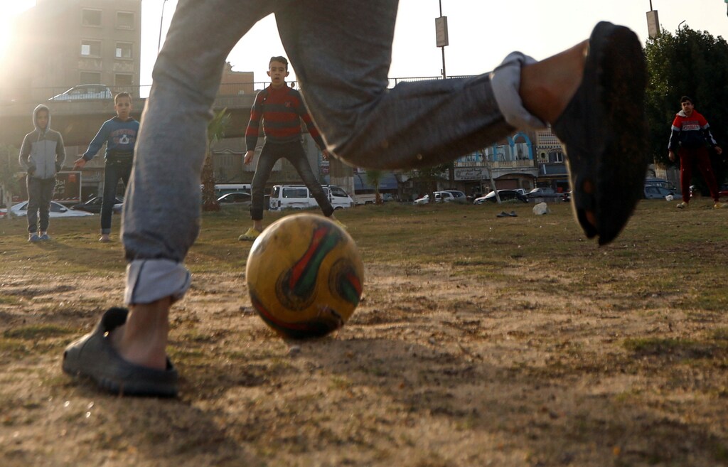 Egyptian children play soccer on a dusty field in Cairo, Egypt January 8, 2019. REUTERS/Amr Abdallah Dalsh - RC117767B380