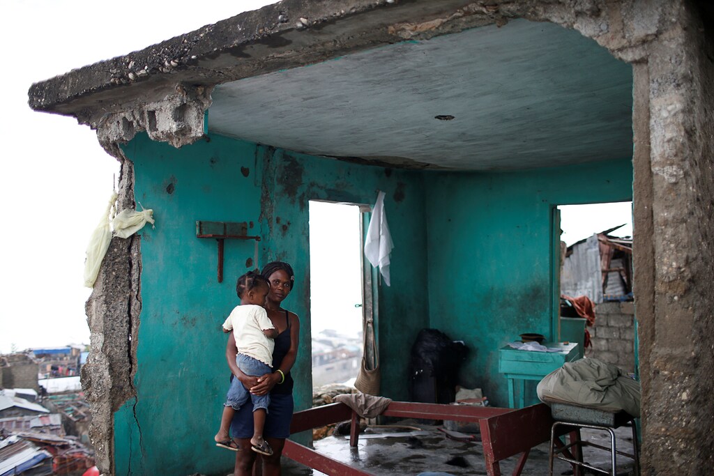 Nathalie Pierre, 28, poses for a photograph with her daughter Rose, 3, in their destroyed house after Hurricane Matthew hit Jeremie, Haiti, October 17, 2016. "As you can see, my situation is very bad. I lost all I had; my house, my money, my boutique. Everything gone in a few minutes. The storm was terrible but I was lucky to have my only daughter alive - that's the most important thing. Life goes on," said Pierre. REUTERS/Carlos Garcia Rawlins SEARCH "HAITI PORTRAITS" FOR THIS STORY. SEARCH "WIDER IMAGE" FOR ALL STORIES. - RTX2T057