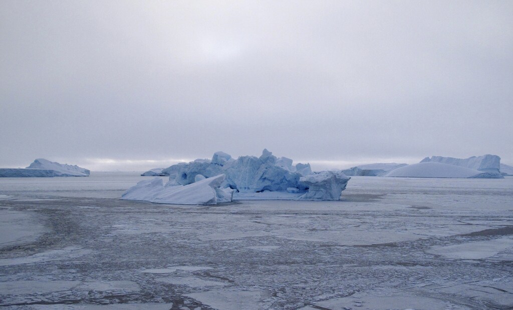 An iceberg floats in the sea ice near the town of Uummannaq in western Greenland March 18, 2010. REUTERS/Svebor Kranjc