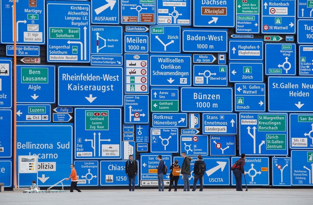 Visitors stand in front of a wall covered with road signs at the Verkehrshaus Luzern (Swiss Museum of Transport) in Luzern, Switzerland November 8, 2018. REUTERS/Arnd Wiegmann - RC19B1DB2800