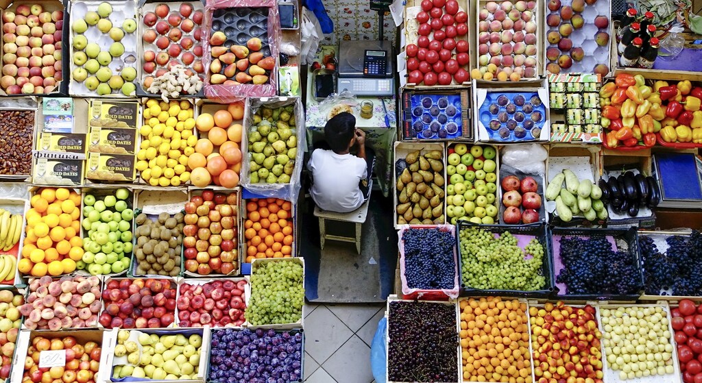 A boy takes a meal break at a fruit stall in the central market in Kazan, Russia, August 11, 2015.
