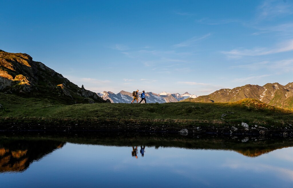 A couple hikes during sunrise on Kreuzjoch mountain in the Zillertal Alps in Schwendau, Austria July 11, 2016. REUTERS/ Dominic Ebenbichler - D1BETOYPXEAB