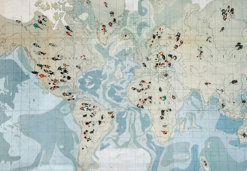 Crowd walking on global map. Composition made with antique map. The global relationship between entrepreneurship and sustainability is deepening.