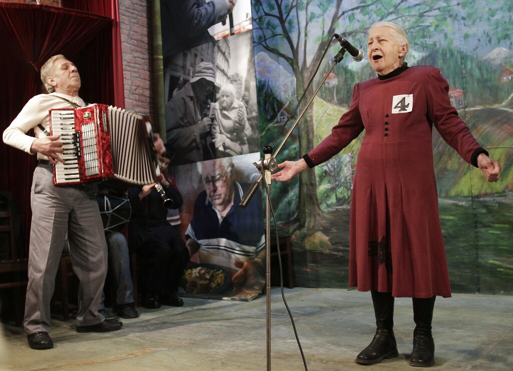Tsiuri Kakabadze (R), 80, performs during the "Super Grandmother and Super Grandfather" contest in Tbilisi January 5, 2011. Twenty-four participants aged over 70 from all over Georgia attended the contest. REUTERS/David Mdzinarishvili (GEORGIA - Tags: SOCIETY ODDLY IMAGES OF THE DAY) - GM1E716051R01
