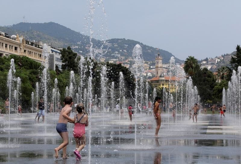 Children play in fountains as a heatwave with high temperatures continues in Nice, France, August 3, 2018.