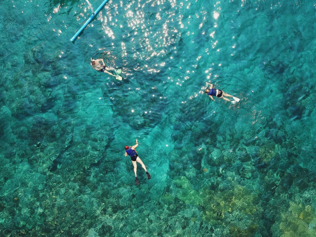 Marine tourism rarely contributes directly towards marine conservation projects. In picture: People scuba-diving in Blue Lagoon, Indonesia.