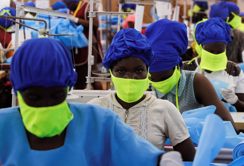 Workers are seen at a production line within the Shona Textiles Export Processing Zone (EPZ) as they make protective face masks and Personal Protective Equipment (PPE), as a measure to stem the coronavirus disease (COVID-19) outbreak, in Athi River near Nairobi, Kenya April 14, 2020. REUTERS/Njeri Mwangi TPX IMAGES OF THE DAY - RC2E4G93D3EW