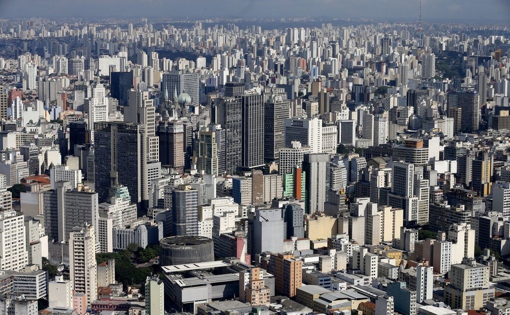 Improving access to digital payments for all sectors of society is a key part of expanding financial inclusion more generally. Pictured here: Wide aerial shot of buildings in a city
