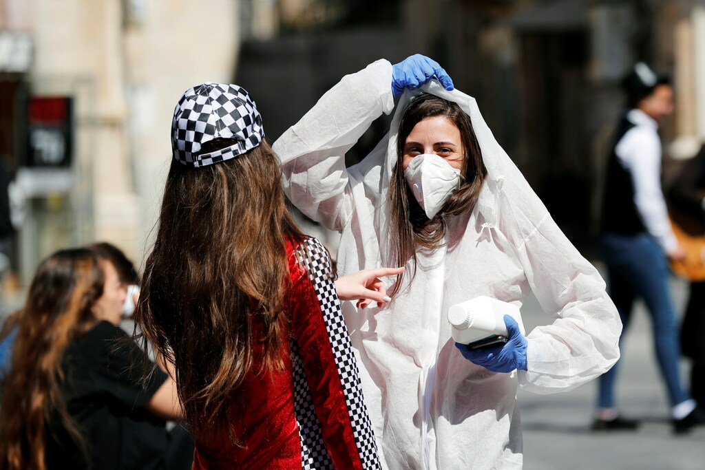 A teenager wears a costume as a reference to the coronavirus during the Jewish holiday of Purim, a celebration of the Jews' salvation from genocide in ancient Persia, as recounted in the Book of Esther. in Jerusalem March 8, 2020. REUTERS/Ronen Zvulun Coronavirus china virus health healthcare who world health organization disease deaths pandemic epidemic worries concerns Health virus contagious contagion viruses diseases disease lab laboratory doctor health dr nurse medical medicine drugs vaccines vaccinations inoculations technology testing test medicinal biotechnology biotech biology chemistry physics microscope research influenza flu cold common cold bug risk symptomes respiratory china iran italy europe asia america south america north washing hands wash hands coughs sneezes spread spreading precaution precautions health warning covid 19 cov SARS 2019ncov wuhan sarscow wuhanpneumonia pneumonia outbreak patients unhealthy fatality mortality elderly old elder age serious death deathly deadly