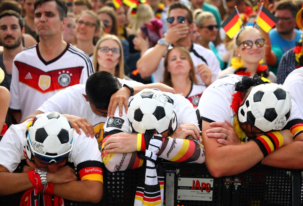Soccer Football - World Cup - Group F - South Korea v Germany - Berlin, Germany - June 27, 2018 - Germany fans react as they watch the match at a public viewing area at Brandenburg Gate. REUTERS/Hannibal Hanschke TPX IMAGES OF THE DAY - RC12FBBBA6D0