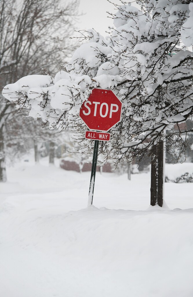 A stop sign is surrounded by record-breaking snowfall that had already surpassed 5 feet (1.5 meters), breaking city and state records, according to the National Weather Service in Erie, Pennsylvania, U.S., December 27, 2017. REUTERS/Robert Frank - RC1264C80420