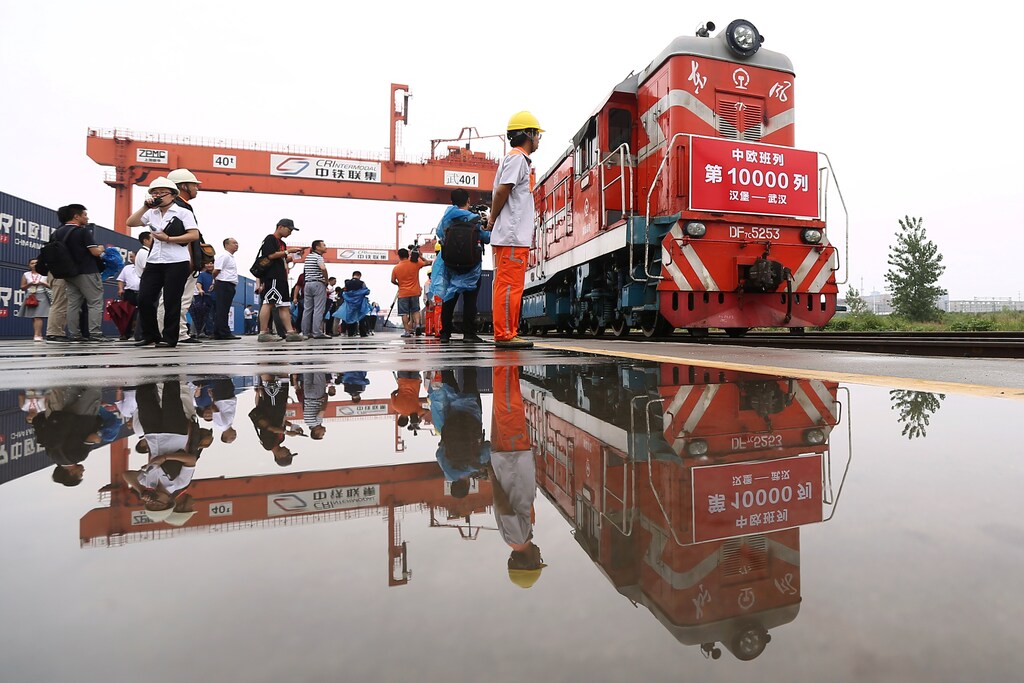People are seen next to a China-Europe freight train that completes its 10,000th trip as it returns from Hamburg, Germany to Wuhan, Hubei province, China August 26, 2018. Picture taken August 26, 2018. China Daily via REUTERS ATTENTION EDITORS - THIS IMAGE WAS PROVIDED BY A THIRD PARTY. CHINA OUT. - RC1C4FDCD000