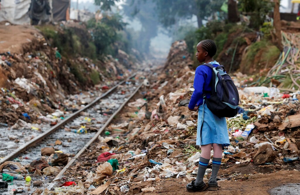 A schoolgirl stands next to the Kenya-Uganda railway line during the partial reopening of schools, after the government scrapped plans to cancel the academic year due to the coronavirus disease (COVID-19) pandemic, in Kibera slums of Nairobi, Kenya October 12, 2020. REUTERS/Thomas Mukoya TPX IMAGES OF THE DAY - RC2WGJ9G86NR