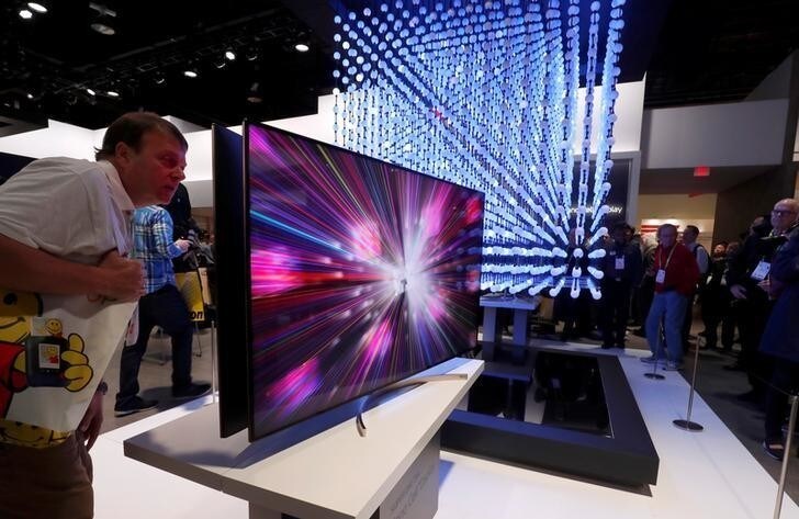 A man looks over a 4K Super UHD TV Nano Cell display in the LG Electronics booth at the Las Vegas Convention Center during the 2018 CES in Las Vegas, Nevada, U.S. January 9, 2018. REUTERS/Steve Marcus