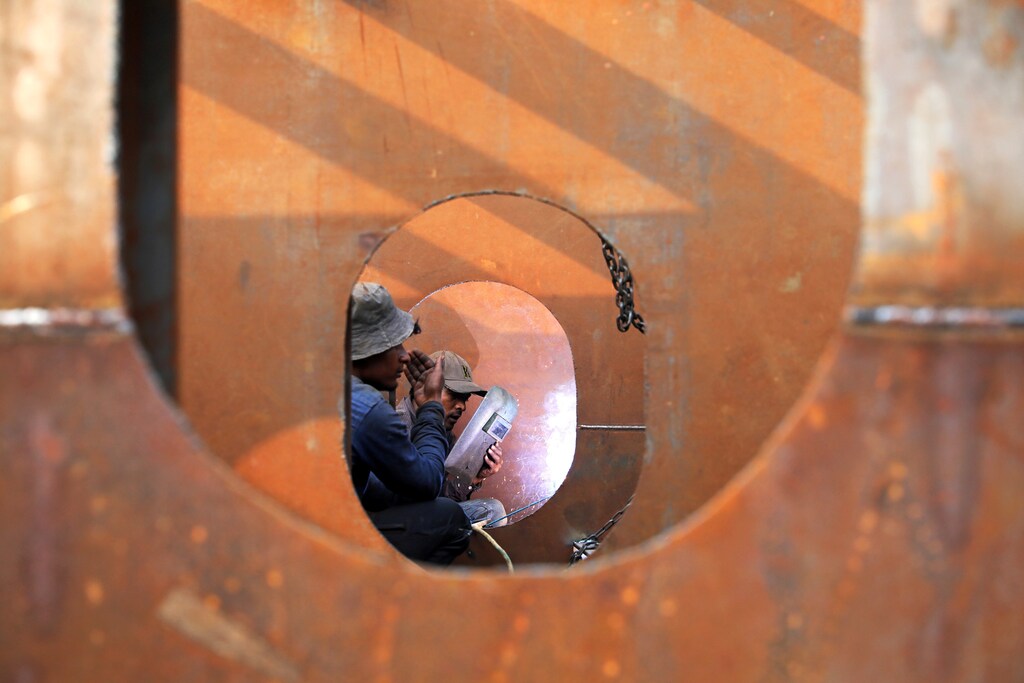 Workers weld iron sheets as they build a new ferry at a dockyard in Dhaka, Bangladesh, February 7, 2019