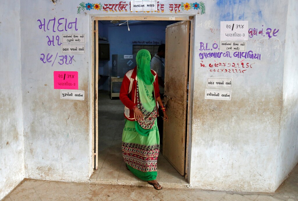 A woman leaves a polling booth after casting her vote during the first phase of Gujarat state assembly election in Panshina village of Surendranagar district December 9, 2017. REUTERS/Amit Dave - RC1753A326D0