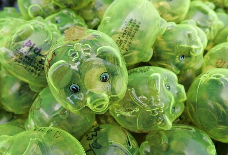 Piggy banks filled with money are piled up during a "Save Our Economy" campaign by Korea Saemaulundong Centre in Seoul April 7, 2009. The piggy banks were distributed to people by the centre and re-collected with donations to help the unfortunate who are suffering due to the global economy crisis.