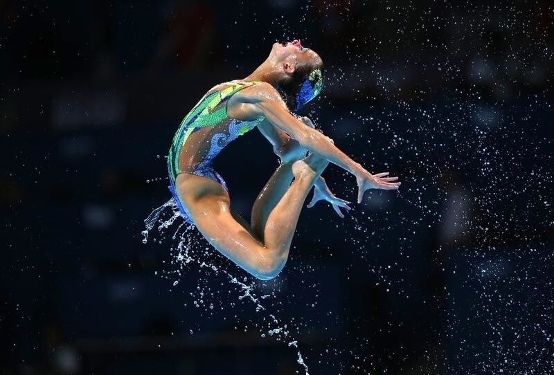 Britain's team perform in the synchronised swimming team free final during the World Swimming Championships at the Sant Jordi arena in Barcelona July 26, 2013. REUTERS/Albert Gea (SPAIN - Tags: SPORT SWIMMING TPX IMAGES OF THE DAY) FOR BEST QUALITY IMAGE ALSO SEE: GF2EA660NDH01 - LR2E97Q1BXPTD