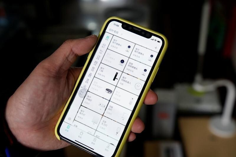 Pan Weida, 31, shows Xiaomi's app on his phone in Shanghai, China February 10, 2018. Picture taken February 10, 2018.