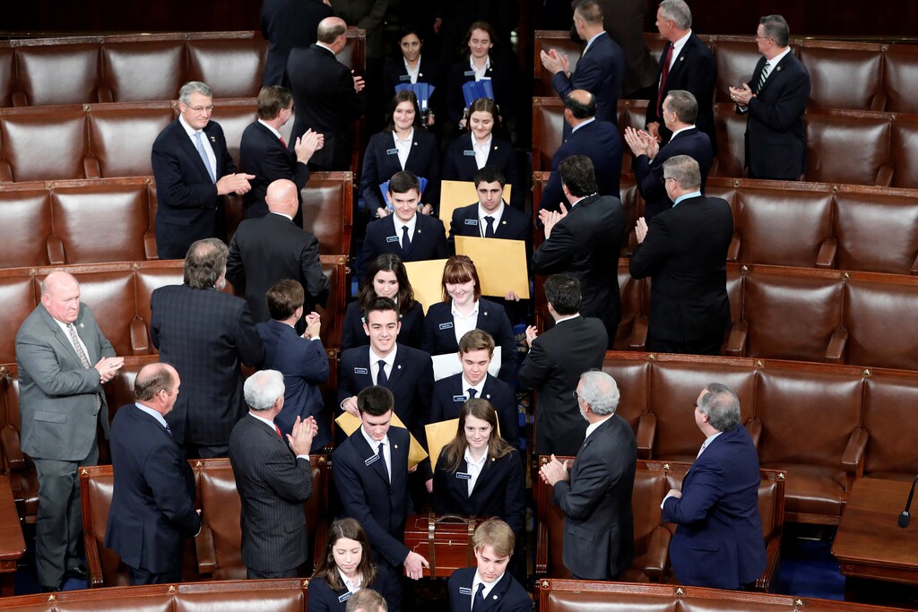 Congressional pages carry in cases the Electoral College votes during a joint session of Congress on Capitol Hill in Washington, U.S., January 6, 2017. REUTERS/Aaron P. Bernstein - RC1A5CF5C130
