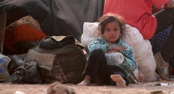 A refugee girl rests, among Iraqi refugees that fled violence in Mosul and internally displaced Syrians whom fled Islamic State controlled areas in Deir al-Zor, near the Iraqi border