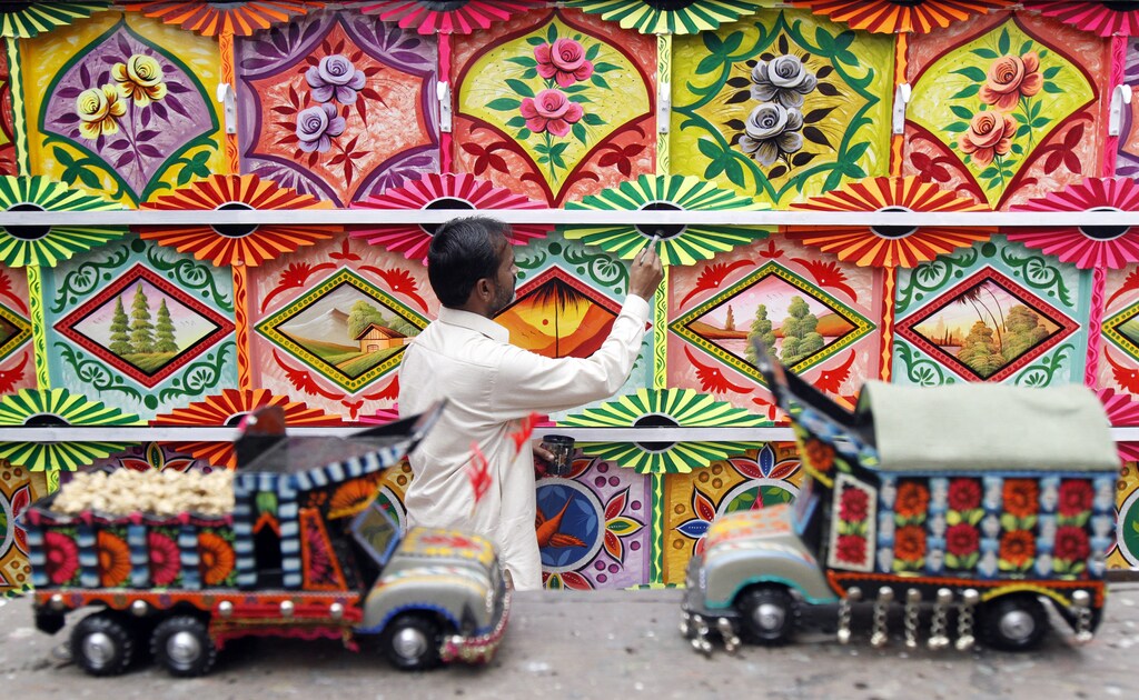 A Muslim artist from Pakistan paints a platform for the Hindu Durga Puja festival