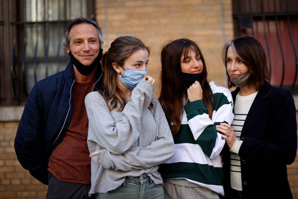 Maree Johnson-Baruch (R), a Broadway performer, poses with her family, husband Jason and teenage daughters Audra and Helena, all of whom have recovered from becoming sick with the coronavirus disease (COVID-19), outside their home in Manhattan in New York City, New York, U.S., May 5, 2020. Picture taken May 5, 2020. REUTERS/Mike Segar - RC2MJG9H06L4