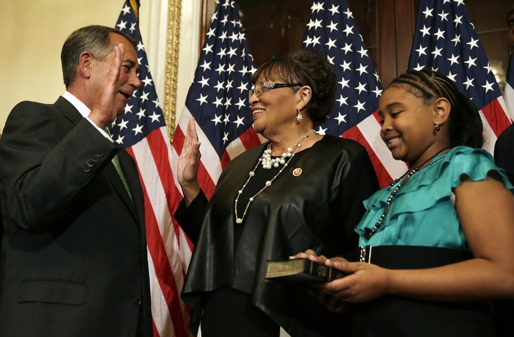 U.S. Speaker of the House John Boehner (R-OH) (L) performs a ceremonial swearing for Rep. Alma Adams (D-NC) (C), one of the new members of the 113th Congress, in Washington November 12, 2014. Adams is the 100th woman serving in the current 113th U.S. Congress. Girl at right is unidentified. REUTERS/Gary Cameron (UNITED STATES - Tags: POLITICS ELECTIONS) - GM1EABD0NMF01