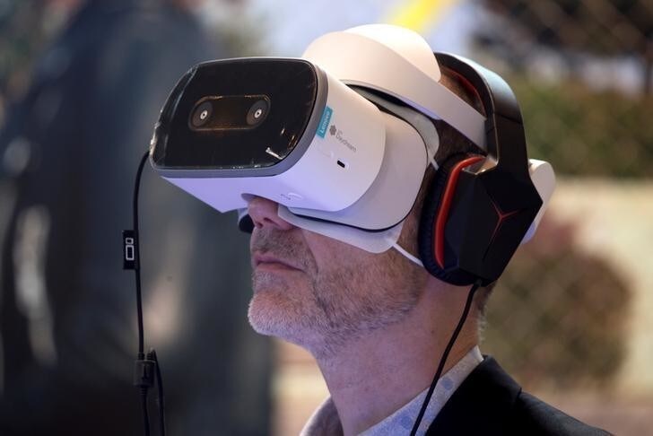 A visitor uses a Lenovo Daydream View VR headset during the Viva Tech start-up and technology summit in Paris, France, May 25, 2018. REUTERS/Charles Platiau