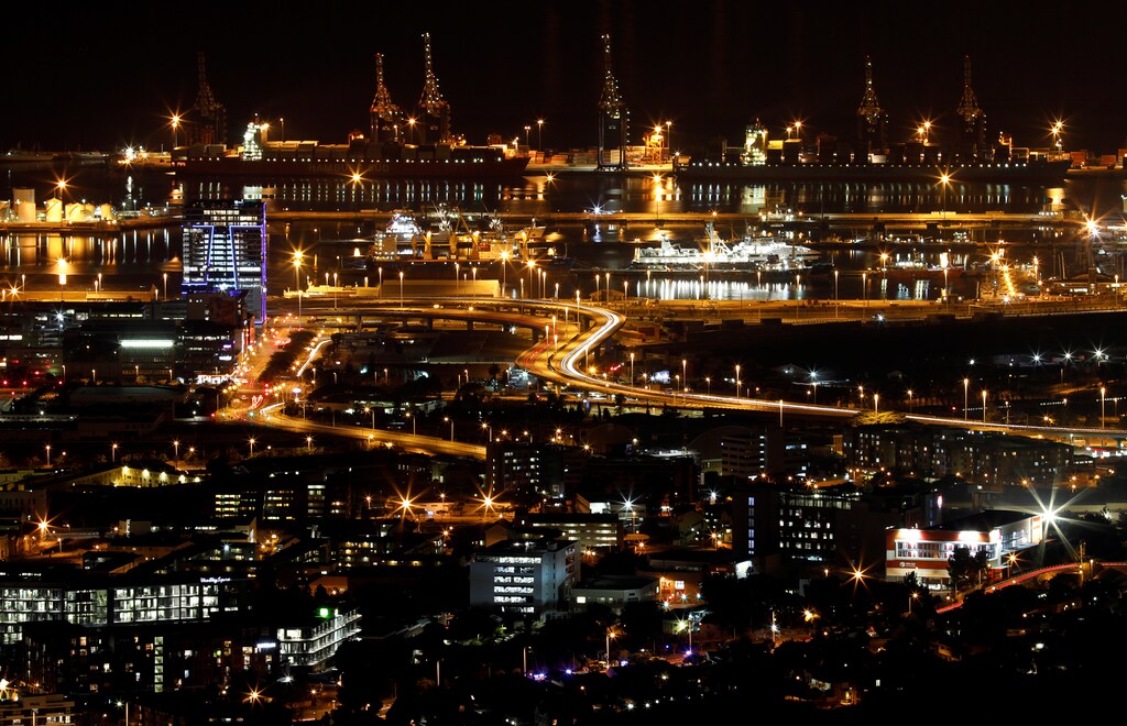Electricity lights up buildings and shipping berthed in the port of Cape Town, South Africa, June 18, 2019. REUTERS/Mike Hutchings - RC1111ED4430