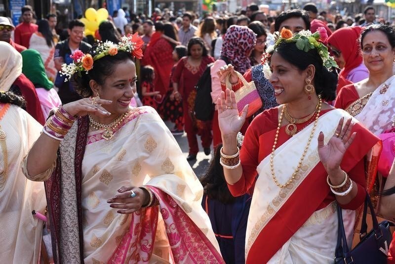 Moushumi Sutradhar, a Bangladeshi American, dances with her friend during celebrations for the Bengali New Year, which is also referred to as Pahela Baishakh, in Jackson Heights, Queens, New York, U.S. April 14, 2018.
