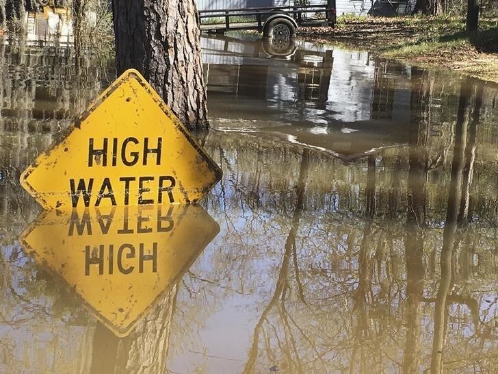 A high water sign is submerged near Lake Bistineau in Webster Parish, Louisiana March 14, 2016. The death toll from storms in Southern U.S. states rose to five as storm-weary residents of Louisiana and Mississippi watched for more flooding on Monday from drenching rains that inundated homes, washed out roads and prompted thousands of rescues.