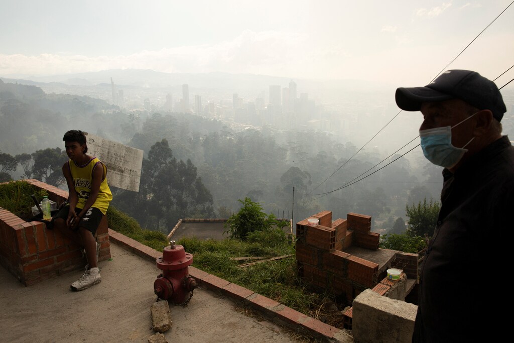 A man wears a face mask after the district government declared an air quality emergency due to forest fires on a hill, in Bogota, Colombia, January 26, 2024. Poor air quality is the number one health risk facing humankind.