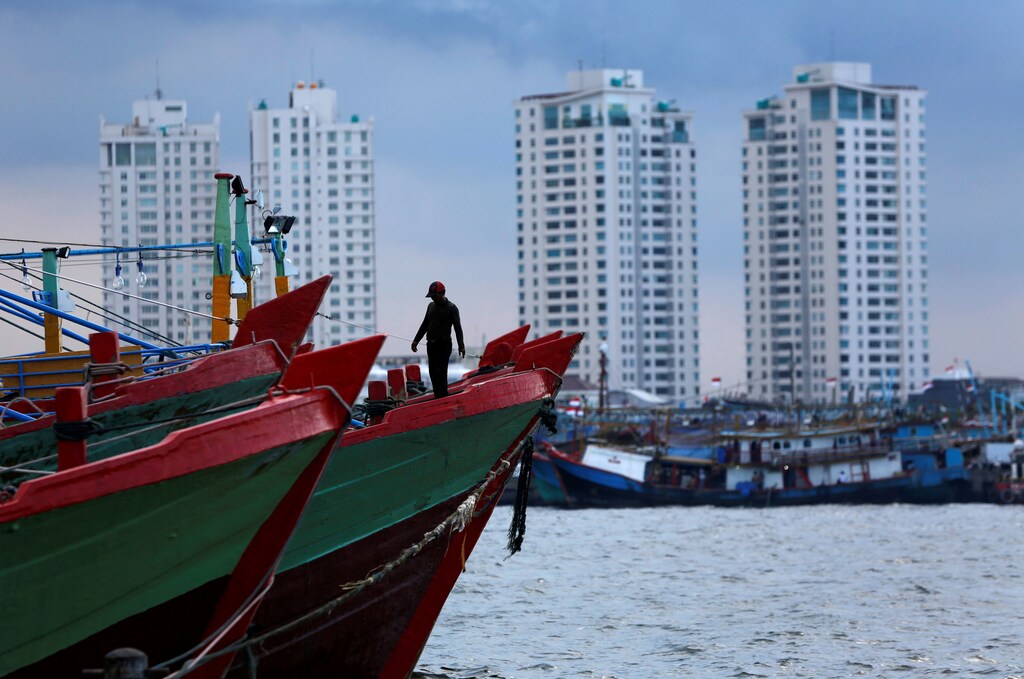 A worker walks on top of wooden boat at Muara Baru port in Jakarta December 8, 2014. REUTERS/Beawiharta/File Photo GLOBAL BUSINESS WEEK AHEAD PACKAGE - SEARCH 'BUSINESS WEEK AHEAD 31 OCT' FOR ALL IMAGES - RTX2R4R2