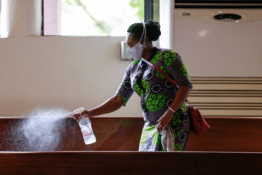 A worker sprays disinfectant on the chairs, after a church service as worship centers were reopened following the ease of restrictions imposed to curb the spread of the coronavirus disease (COVID-19) in Abuja, Nigeria June 7, 2020. REUTERS/Afolabi Sotunde - RC2B4H9IEXBX