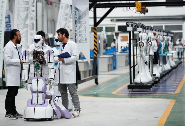 Ozgur Akin, Chairman and founder of Akinsoft, and engineers check an "ADA GH5" humanoid hybrid robot at Akinrobotics, the country's first-ever factory to mass produce humanoid robots, in Konya, Turkey, December 8, 2017. Picture taken December 8, 2017. REUTERS/Murad Sezer