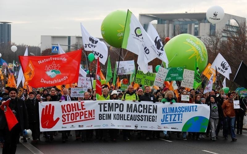 Environmental activists march during an anti-coal protest on the occasion of the Katowice Climate Change Conference in front of the Chancellery in Berlin, Germany December 1, 2018. The banner (L) reads "Stop coal!" REUTERS/Fabrizio Bensch - RC156F666290