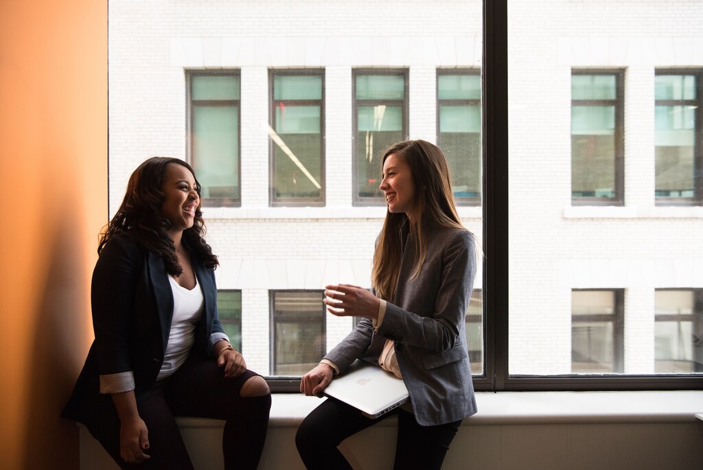 Two happy female workers, illustrating the importance of workforce sustainability