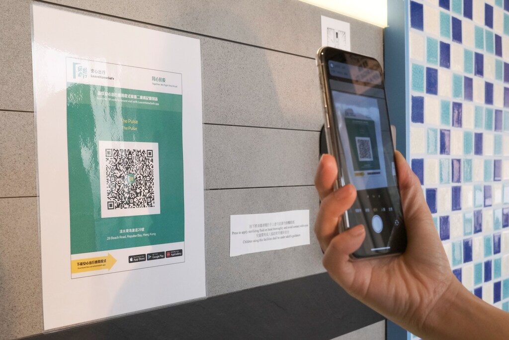 A QR code for the "LeaveHomeSafe" COVID-19 contact-tracing app is posted at a shopping mall, following the coronavirus disease (COVID-19) outbreak, in Hong Kong, China February 16, 2021. REUTERS/Tyrone Siu - RC2NTL9XCG3V