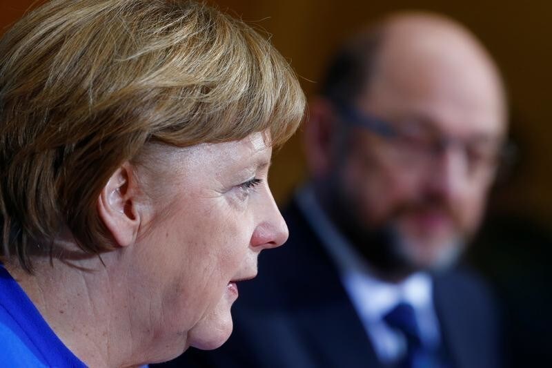 Acting German Chancellor Angela Merkel and Social Democratic Party (SPD) leader Martin Schulz attend a news conference after exploratory talks about forming a new coalition government at the SPD headquarters in Berlin, Germany, January 12, 2018. REUTERS/Hannibal Hanschke - RC16CC964950